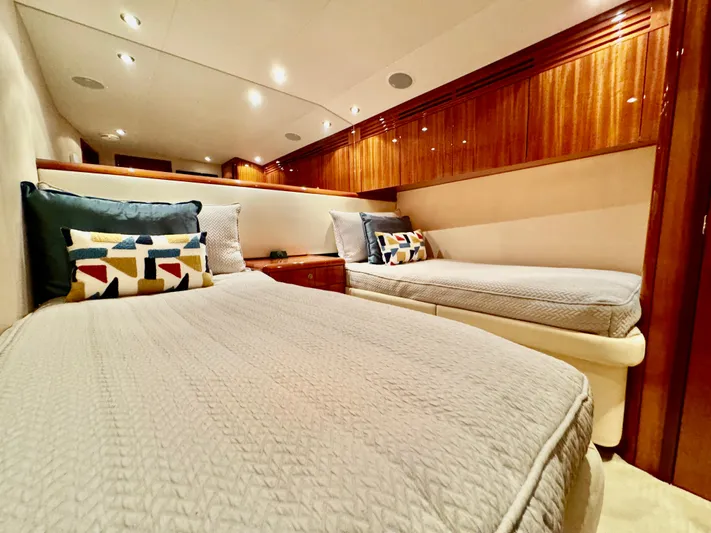 Red Queen Yacht Photos Pics Luxurious 2008 Hatteras Enclosed Bridge cabin with twin beds and elegant wood paneling.