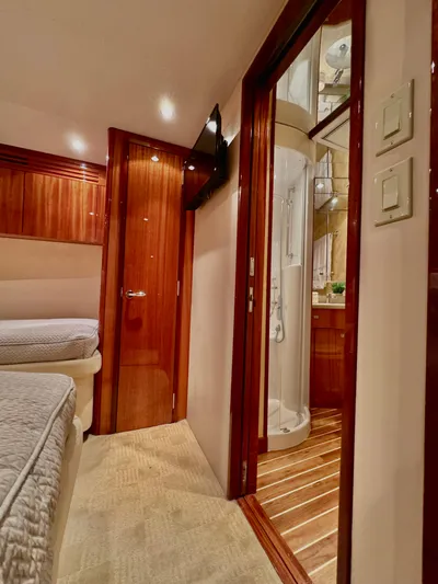 Red Queen Yacht Photos Pics Interior of 2008 Hatteras Enclosed Bridge yacht with wood finishes and modern amenities.