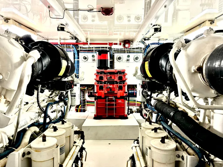 Red Queen Yacht Photos Pics Engine room of a 2008 Hatteras Enclosed Bridge yacht, showcasing machinery and equipment.