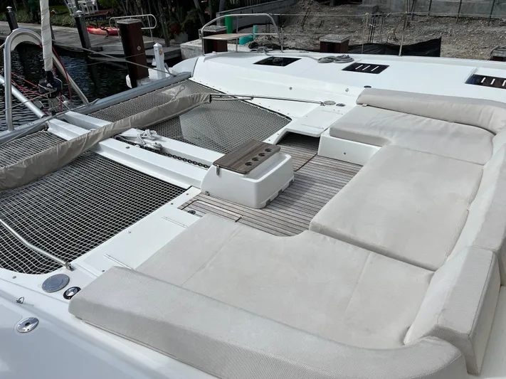  Yacht Photos Pics Spacious deck of 2021 Lagoon 55 catamaran with comfortable seating and netted lounging area.