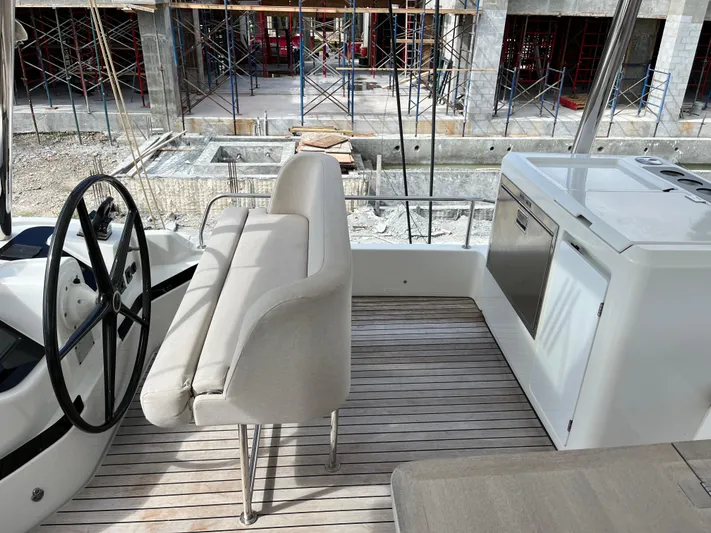  Yacht Photos Pics Lagoon 55 yacht interior with helm, seating, and kitchenette, 2021 model.
