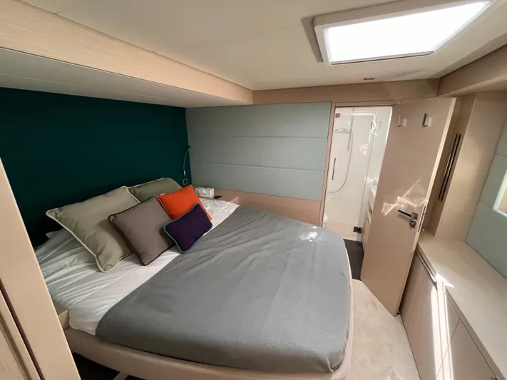  Yacht Photos Pics Luxurious bedroom interior of 2021 Lagoon 55 yacht with modern design and ensuite bathroom.