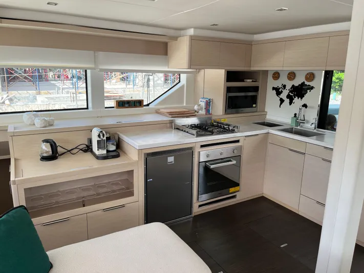  Yacht Photos Pics Modern kitchen interior of 2021 Lagoon 55 yacht with appliances and sleek cabinetry.