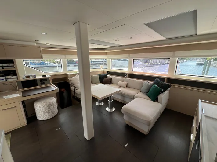  Yacht Photos Pics Luxurious interior of 2021 Lagoon 55 yacht with modern seating and panoramic windows.