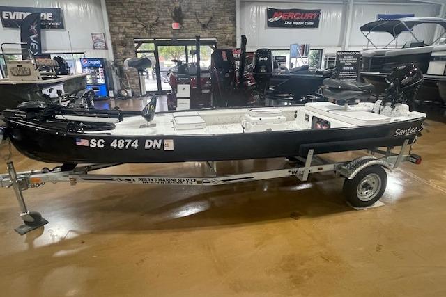 2020 Santee 160TS boat on trailer in showroom, black exterior, displayed indoors.