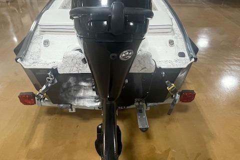 2020 Santee 160TS boat with motor, viewed from the rear on a polished floor.