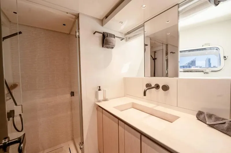  Yacht Photos Pics Luxurious bathroom in 2021 Sanlorenzo SX76 yacht with modern fixtures and elegant design.