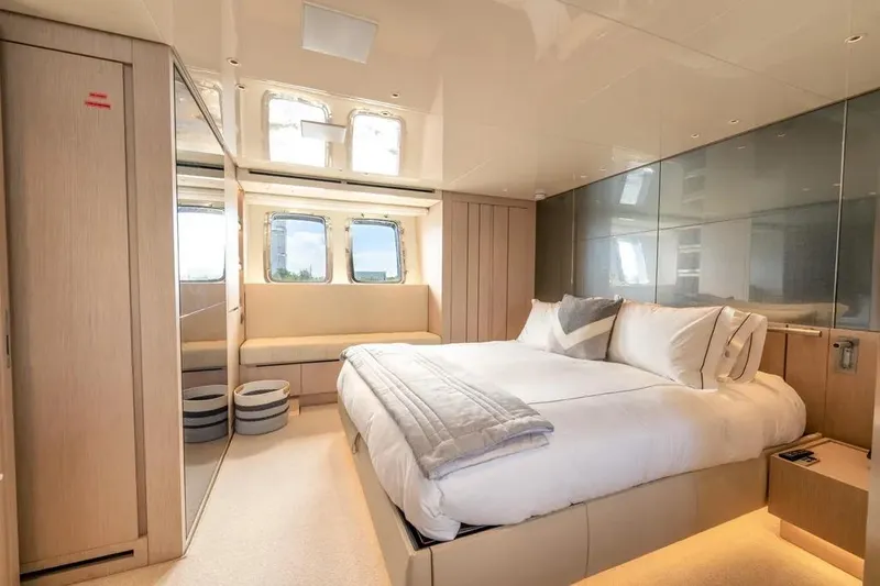  Yacht Photos Pics Luxurious bedroom interior of 2021 Sanlorenzo SX76 yacht with modern design and large windows.