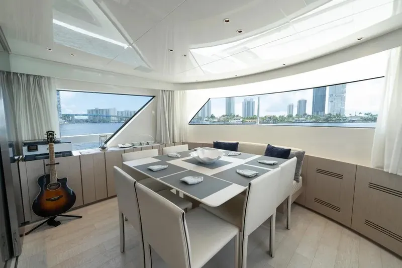  Yacht Photos Pics Luxurious dining area on 2021 Sanlorenzo SX76 yacht with cityscape view.