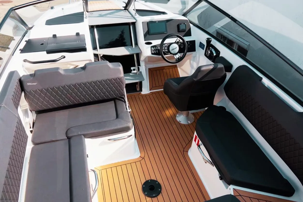 Interior of 2025 Silver VPR DCZ boat with modern seating and wooden flooring.