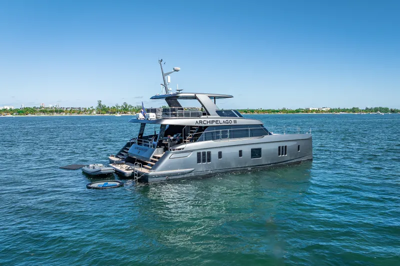 Skip The Wait Yacht Photos Pics Luxurious 2026 Sunreef 60 Power yacht on serene blue waters.