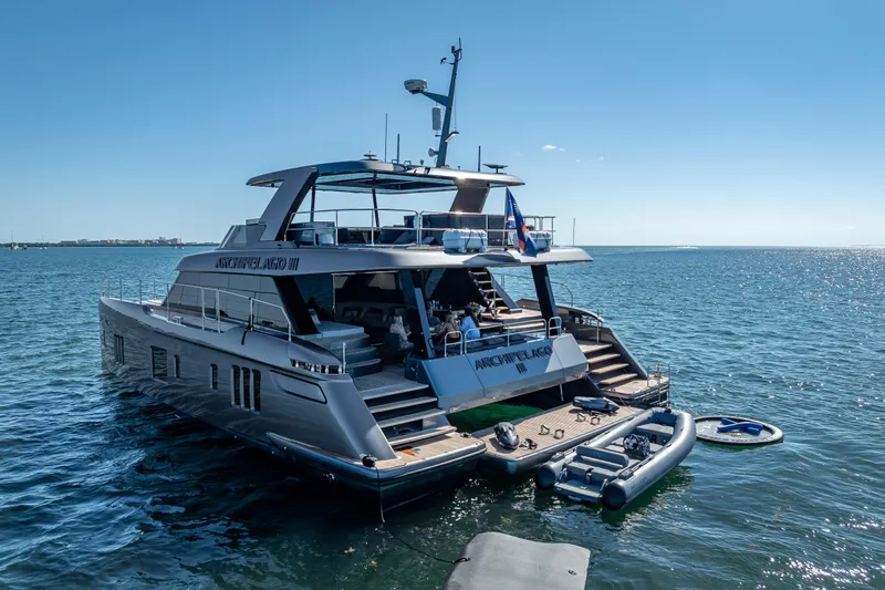 Skip The Wait Yacht Photos Pics 2026 Sunreef 60 Power yacht on calm sea, featuring luxurious design and spacious deck.