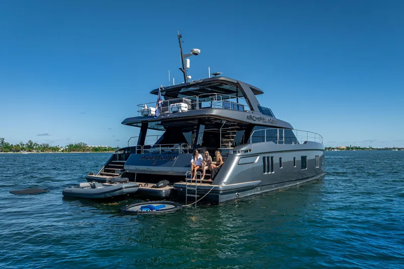 Skip The Wait Yacht Photos Pics Luxurious 2026 Sunreef 60 Power yacht on serene water, featuring sleek design and spacious deck.