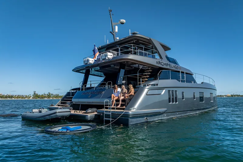 Skip The Wait Yacht Photos Pics 2026 Sunreef 60 Power yacht on water, people relaxing on deck, clear sky.