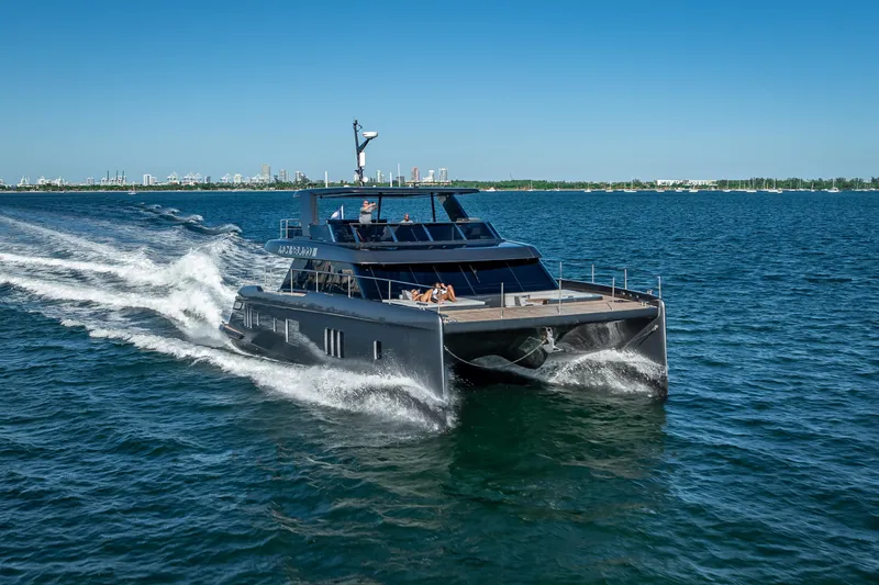 Skip The Wait Yacht Photos Pics 2026 Sunreef 60 Power yacht cruising on open water under clear blue skies.