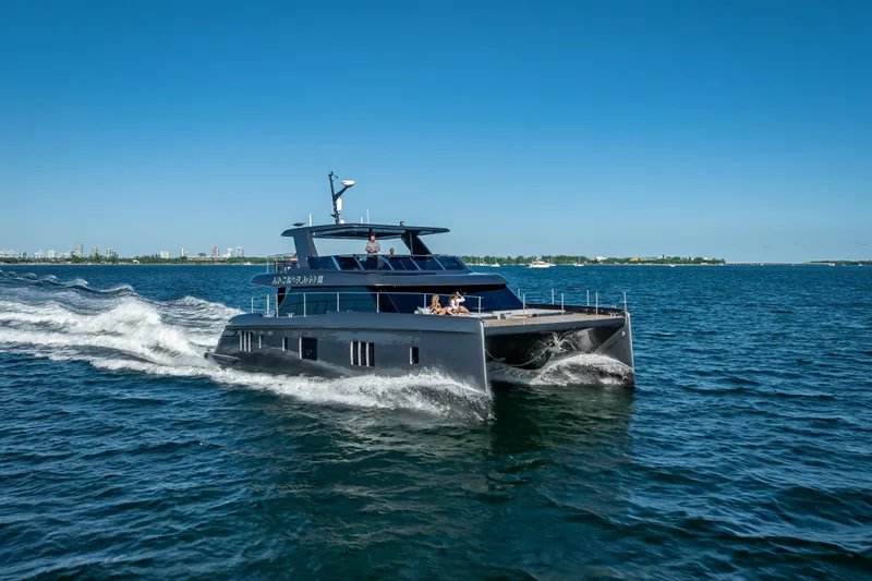 Skip The Wait Yacht Photos Pics 2026 Sunreef 60 Power yacht cruising on open water under clear blue skies.