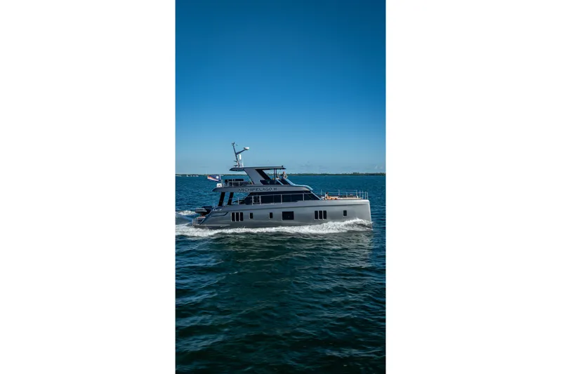 Skip The Wait Yacht Photos Pics 2026 Sunreef 60 Power yacht cruising on open water under clear blue skies.