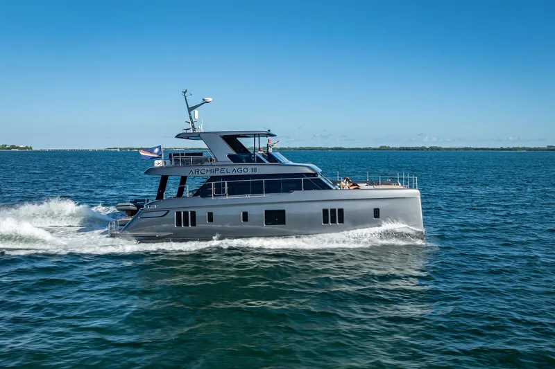 Skip The Wait Yacht Photos Pics 2026 Sunreef 60 Power yacht cruising on open water under clear blue skies.