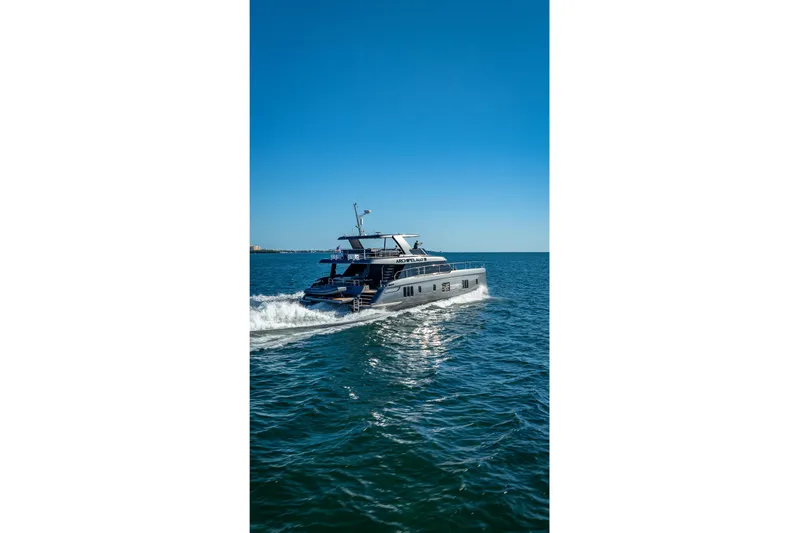 Skip The Wait Yacht Photos Pics 2026 Sunreef 60 Power yacht cruising on open sea under clear blue sky.