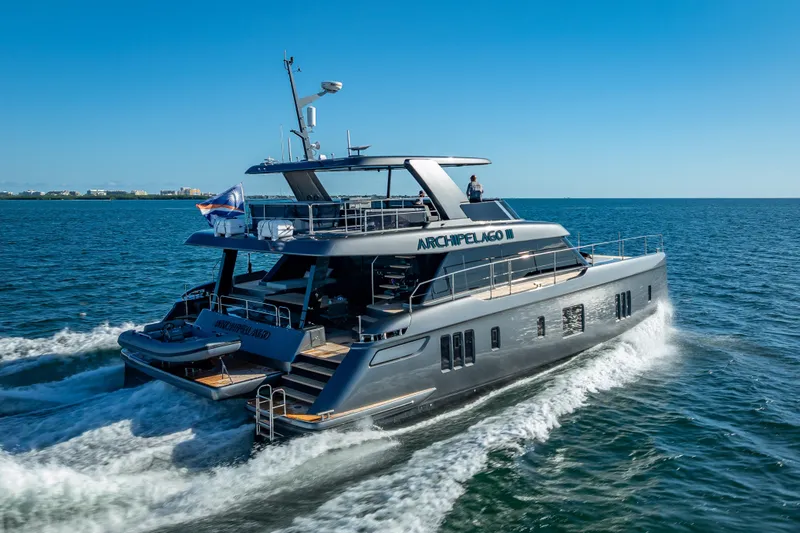 Skip The Wait Yacht Photos Pics 2026 Sunreef 60 Power yacht cruising on open water under clear blue skies.