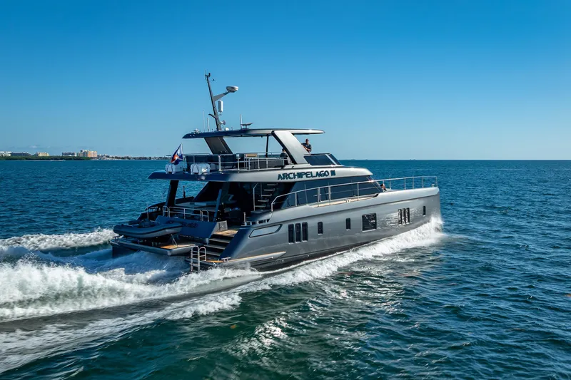 Skip The Wait Yacht Photos Pics 2026 Sunreef 60 Power yacht cruising on open sea under clear blue sky.