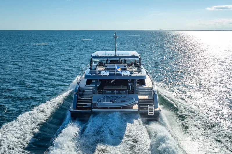 Skip The Wait Yacht Photos Pics 2026 Sunreef 60 Power yacht cruising on open sea, rear view.