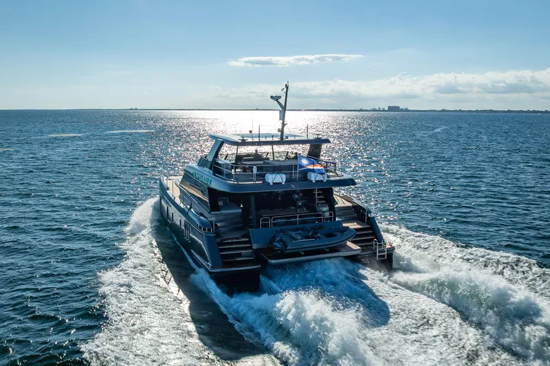 Skip The Wait Yacht Photos Pics 2026 Sunreef 60 Power yacht cruising on open sea under clear blue sky.