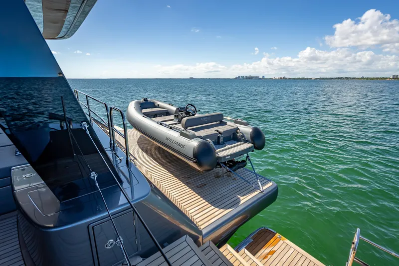 Skip The Wait Yacht Photos Pics 2026 Sunreef 60 Power yacht with tender on deck, overlooking serene ocean view.