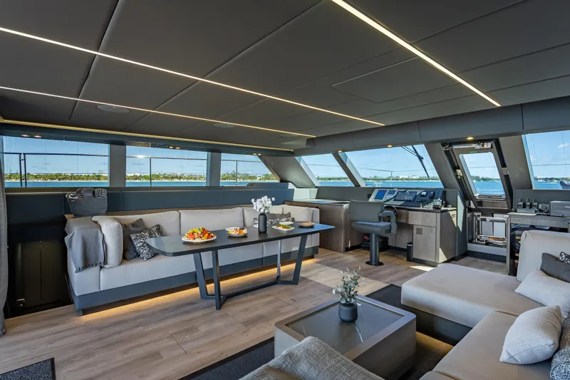 Skip The Wait Yacht Photos Pics Luxurious interior of 2026 Sunreef 60 Power yacht with modern furnishings and panoramic windows.