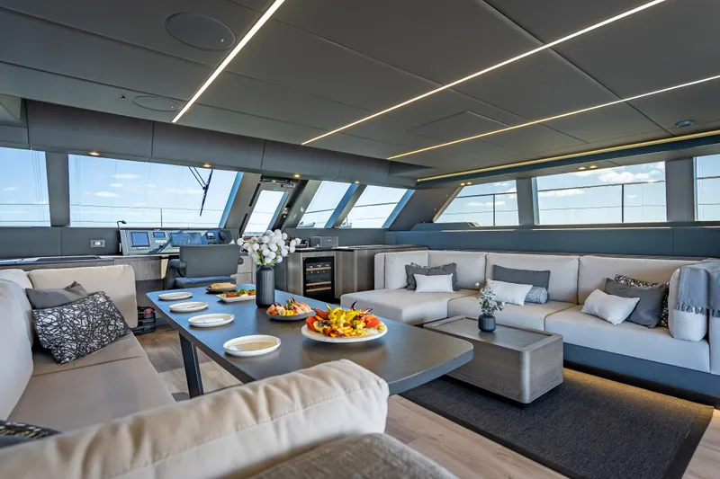 Skip The Wait Yacht Photos Pics Luxurious interior of 2026 Sunreef 60 Power yacht with elegant seating and dining area.