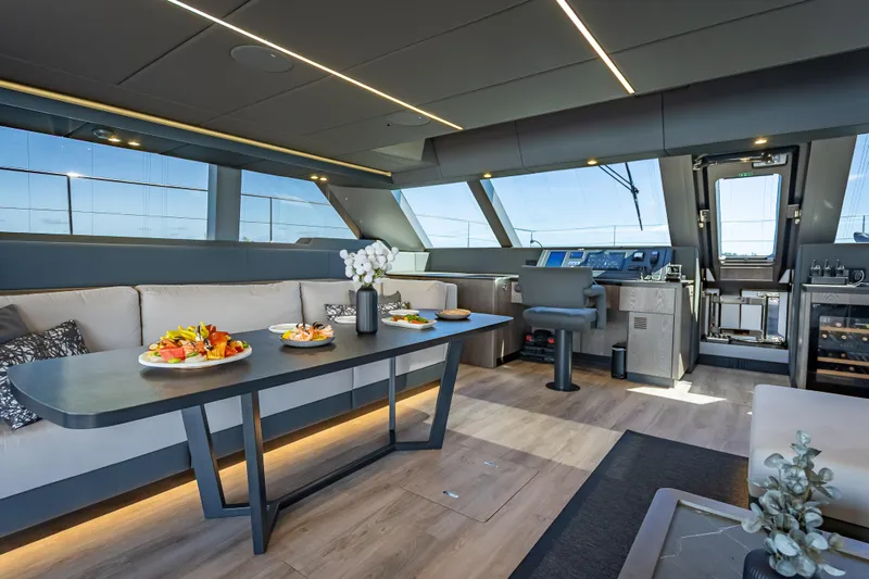 Skip The Wait Yacht Photos Pics Luxurious interior of 2026 Sunreef 60 Power yacht with elegant dining area.