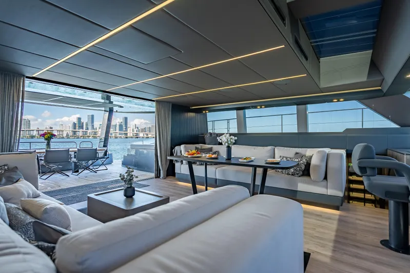 Skip The Wait Yacht Photos Pics Luxurious interior of 2026 Sunreef 60 Power yacht with city skyline view.