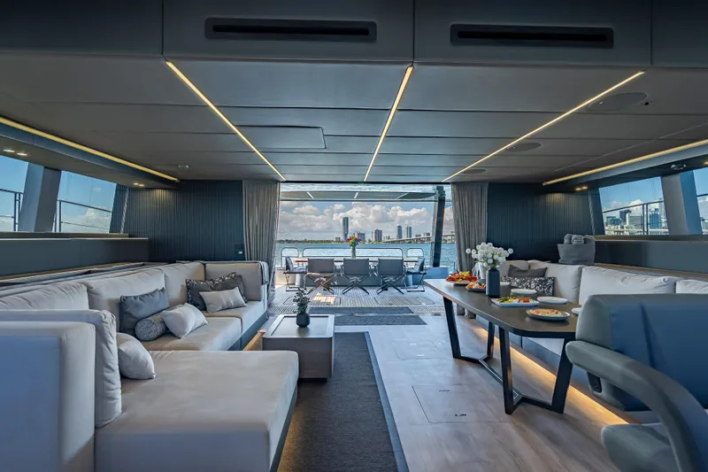 Skip The Wait Yacht Photos Pics Luxurious interior of 2026 Sunreef 60 Power yacht with elegant seating and dining area.
