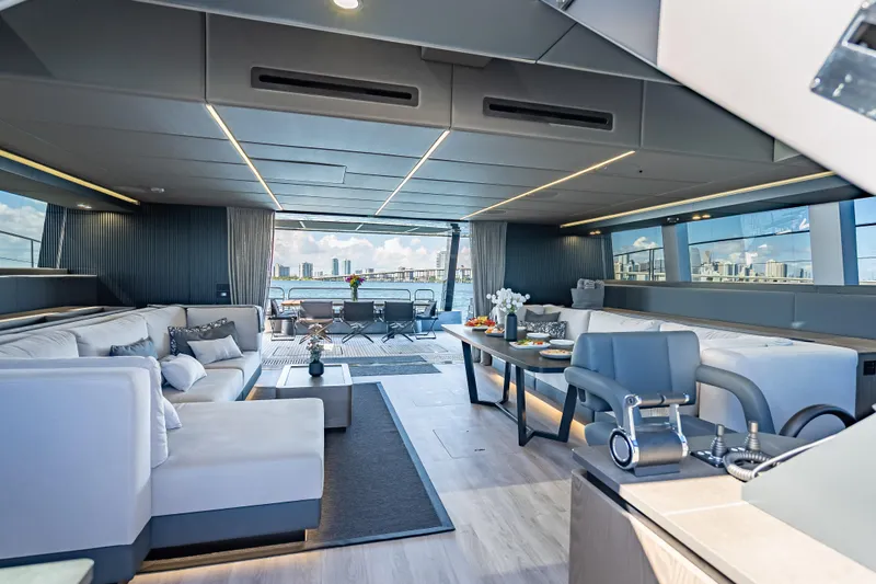 Skip The Wait Yacht Photos Pics Luxurious interior of 2026 Sunreef 60 Power yacht with elegant seating and dining area.