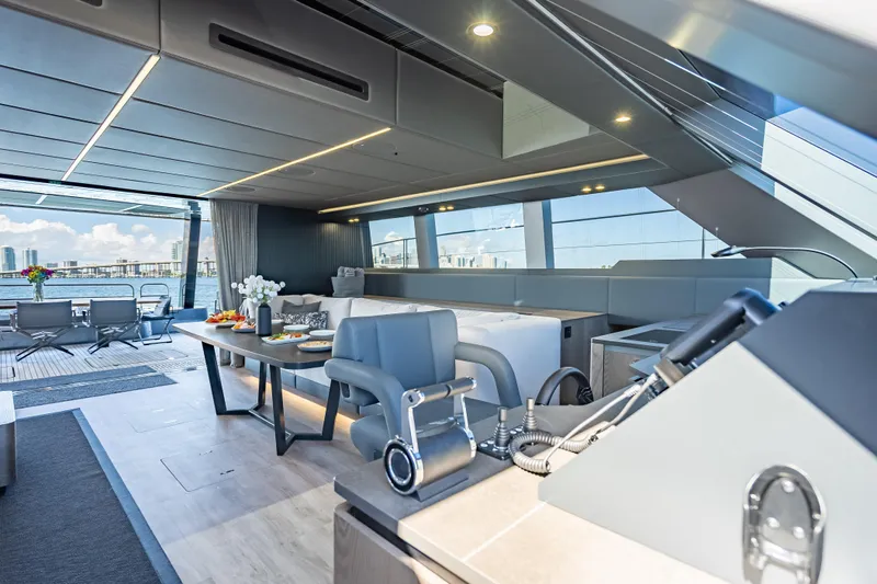 Skip The Wait Yacht Photos Pics Luxurious interior of 2026 Sunreef 60 Power yacht with modern seating and dining area.
