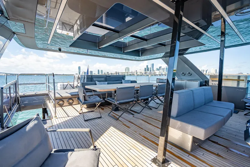 Skip The Wait Yacht Photos Pics Luxurious 2026 Sunreef 60 Power yacht deck with seating, dining area, and ocean view.