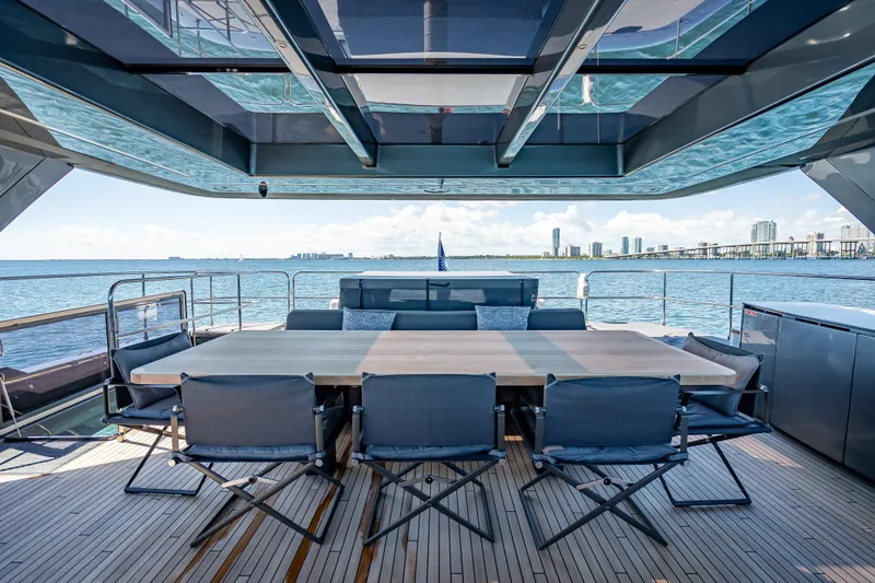 Skip The Wait Yacht Photos Pics Luxurious Sunreef 60 Power yacht deck with dining area, ocean view, and modern design, 2026 model.