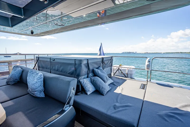 Skip The Wait Yacht Photos Pics Luxurious Sunreef 60 Power yacht deck with comfortable seating, ocean view, and clear skies.