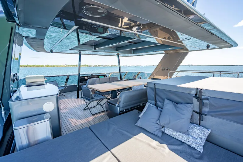 Skip The Wait Yacht Photos Pics Luxurious Sunreef 60 Power yacht deck with seating, table, and ocean view, 2026 model.