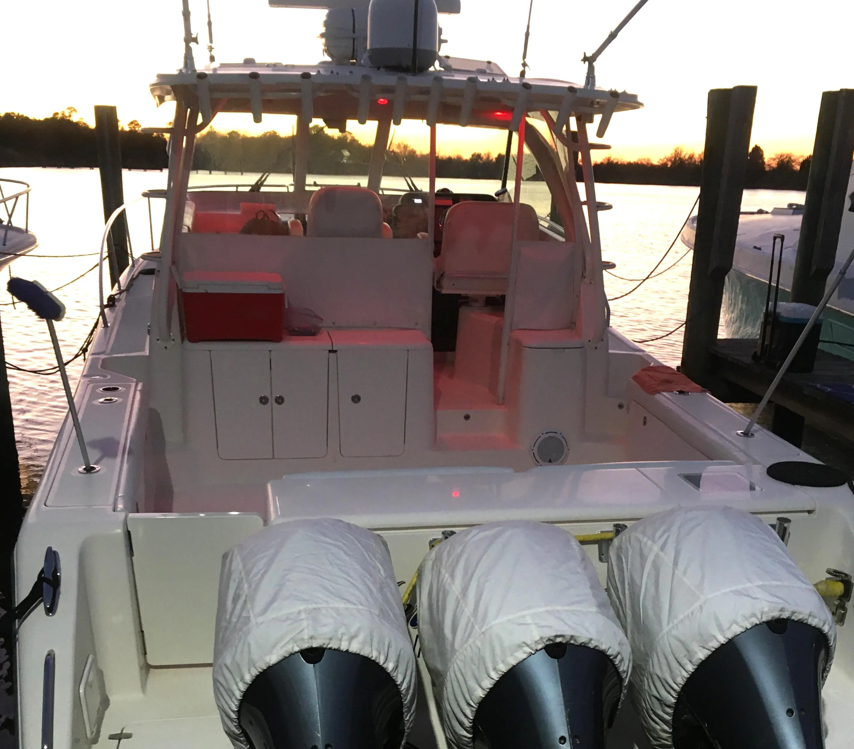 2013 Pursuit OS 385 Offshore boat docked at sunset.
