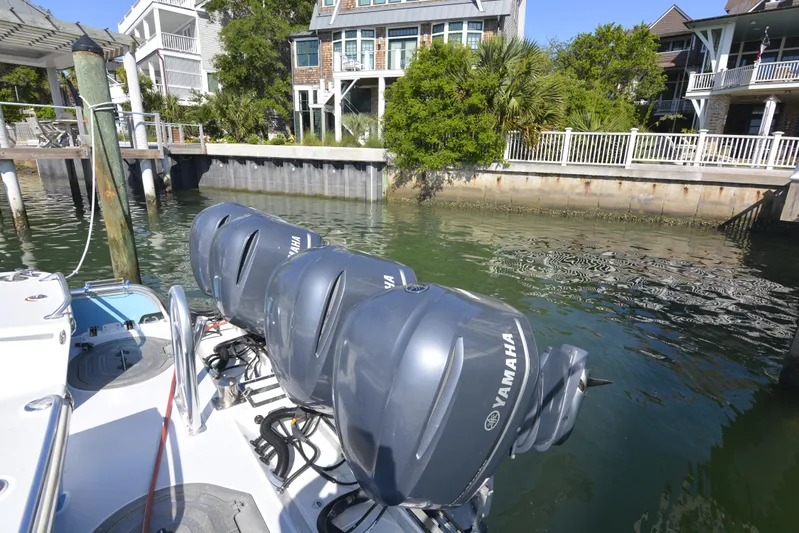 Blue Marble Explorer Yacht Photos Pics Custom 2005 P-38 Lightning Power Catamaran with Yamaha engines docked near waterfront homes.