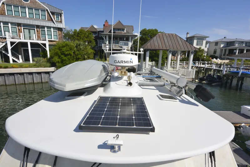 Blue Marble Explorer Yacht Photos Pics 2005 Custom P-38 Lightning Power Catamaran with solar panel and Garmin equipment docked near waterfront homes.