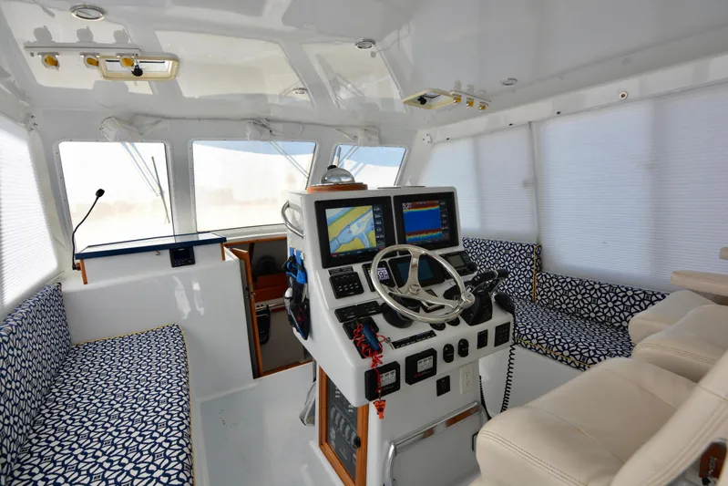 Blue Marble Explorer Yacht Photos Pics 2005 Custom P-38 Lightning Power Catamaran interior with dual steering wheels and navigation screens.