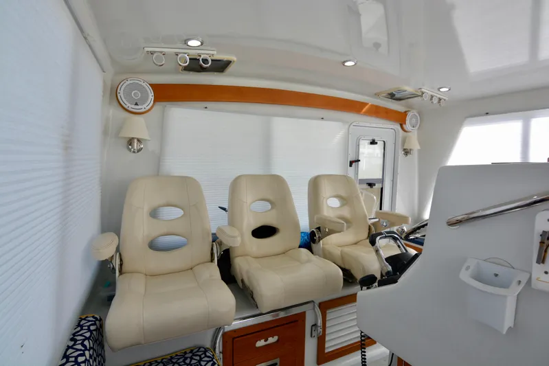 Blue Marble Explorer Yacht Photos Pics Interior of 2005 Custom P-38 Lightning Power Catamaran with three beige captain chairs.