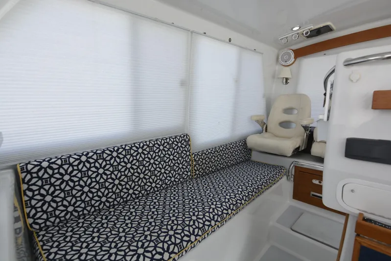Blue Marble Explorer Yacht Photos Pics Interior of 2005 Custom P-38 Lightning Power Catamaran with patterned seating and captain's chair.