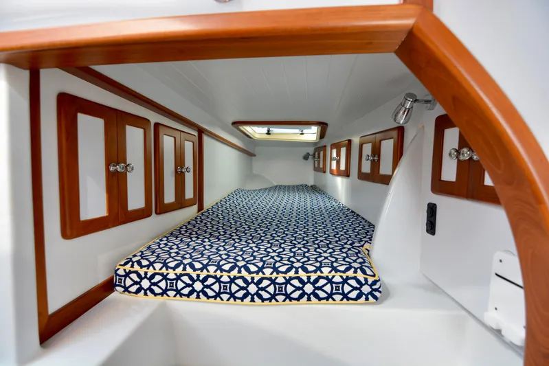 Blue Marble Explorer Yacht Photos Pics Cozy cabin interior of 2005 Custom P-38 Lightning Power Catamaran with patterned bedding.
