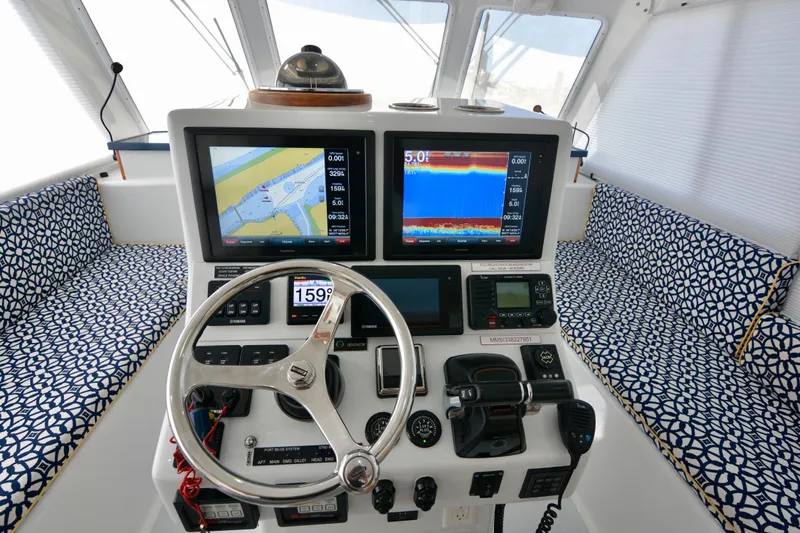 Blue Marble Explorer Yacht Photos Pics Cockpit of 2005 Custom P-38 Lightning Power Catamaran with navigation screens and patterned seating.