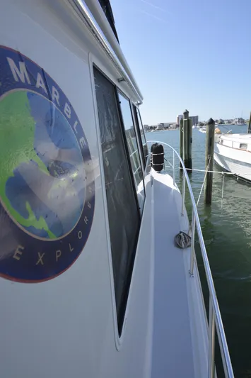 Blue Marble Explorer Yacht Photos Pics Side view of 2005 Custom P-38 Lightning Power Catamaran docked at marina.
