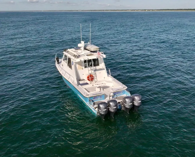 Blue Marble Explorer Yacht Photos Pics Custom 2005 P-38 Lightning Power Catamaran on open water with four outboard motors.