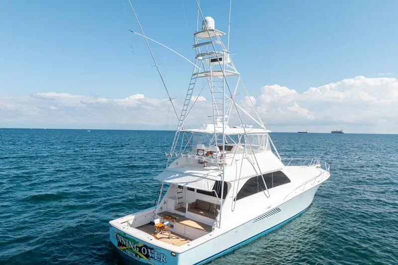 Running Over Yacht Photos Pics 2006 Viking 68 Convertible yacht on open sea under clear blue sky.